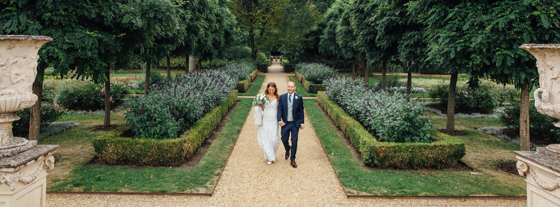 a happy married couple walking at chiswick house and gardens venue on their wedding day