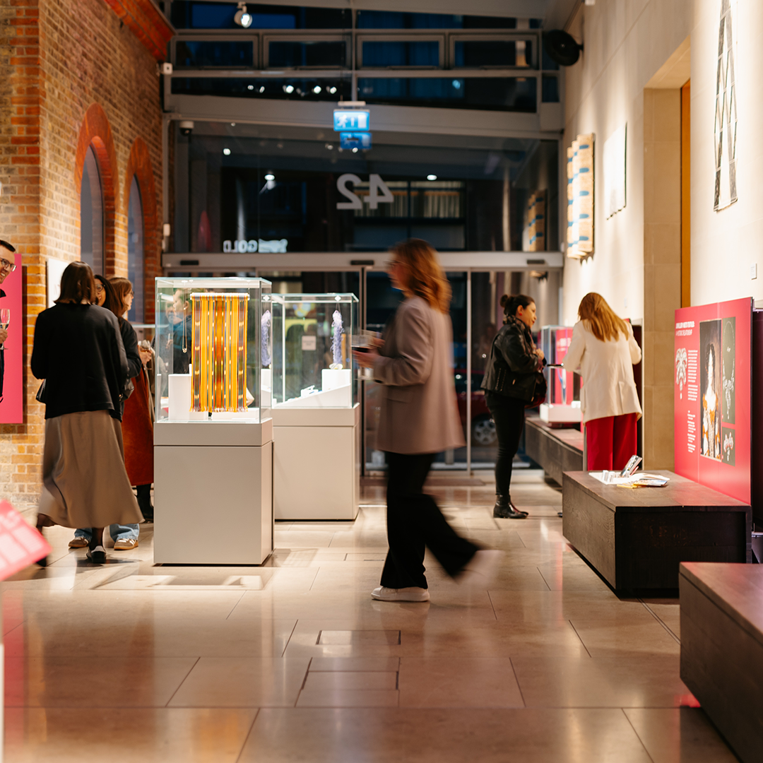 a lady walking across the room at a corporate mixer event
