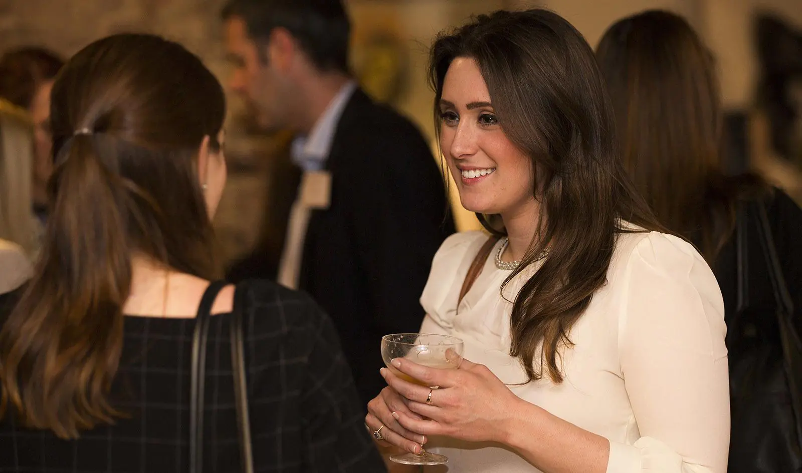 Girl smiling at event with drink